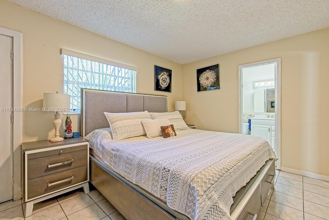 bedroom with a textured ceiling and connected bathroom