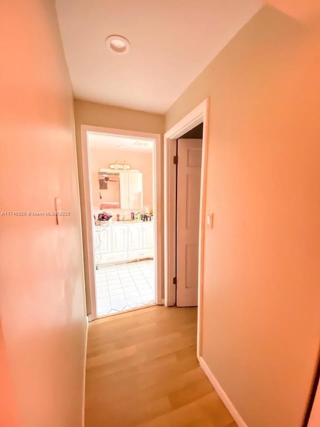 hallway with hardwood / wood-style floors