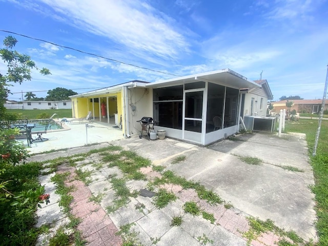 back of property featuring a patio and a sunroom