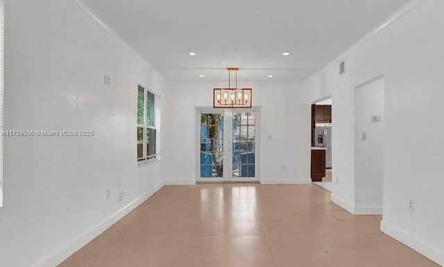 unfurnished room with an inviting chandelier and light tile patterned floors