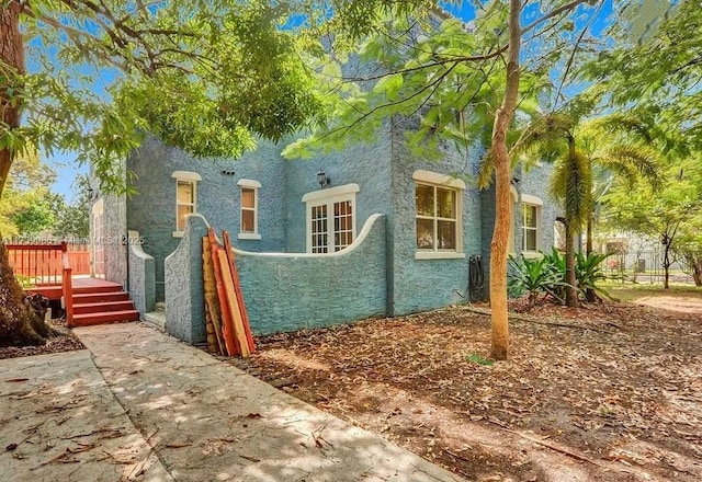 view of property exterior featuring a wooden deck