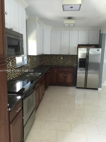 kitchen featuring tasteful backsplash, appliances with stainless steel finishes, sink, and white cabinets