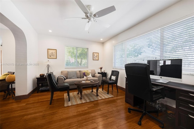 home office with dark wood-type flooring and ceiling fan