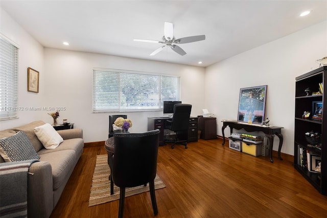 home office with ceiling fan and dark hardwood / wood-style floors