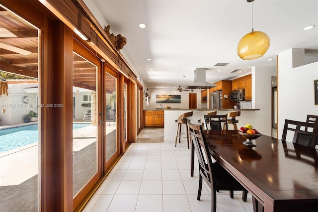 dining space with light tile patterned floors and french doors