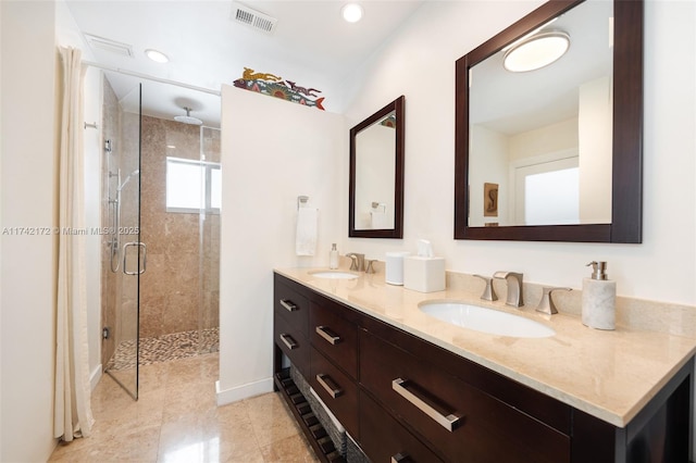 bathroom featuring vanity and a shower with door