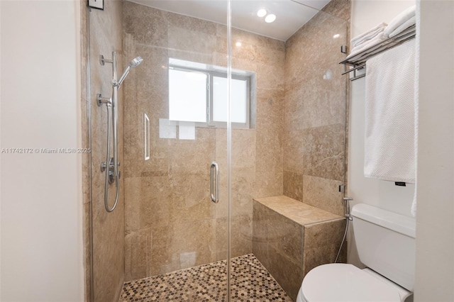 bathroom with walk in shower and toilet