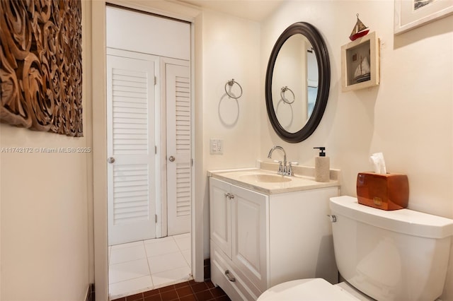 bathroom featuring vanity, toilet, and tile patterned flooring