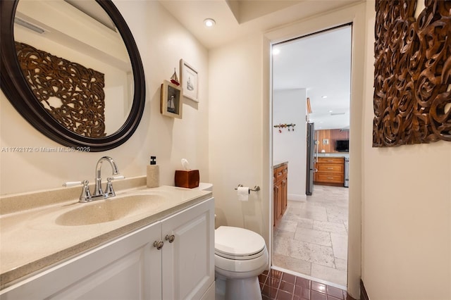 bathroom with vanity and toilet