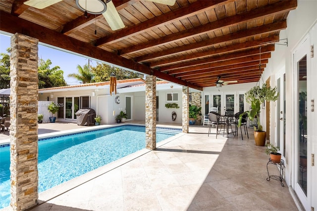 view of pool with a patio, french doors, and ceiling fan