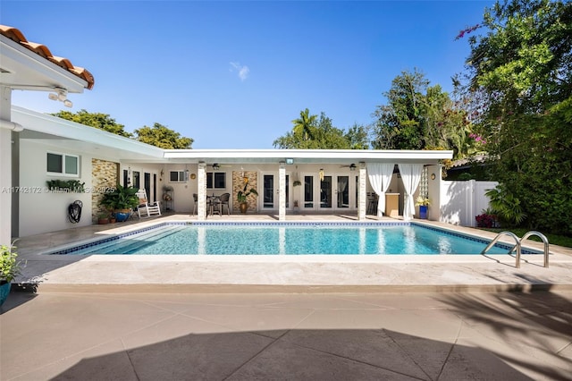 view of swimming pool featuring a patio and french doors