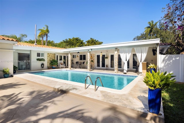 view of pool featuring a patio and french doors