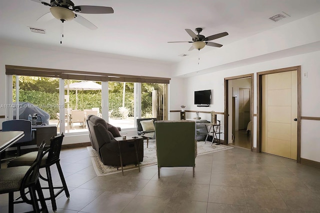 living room with ceiling fan and tile patterned floors