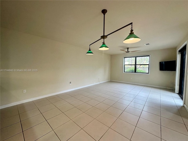 tiled spare room with ceiling fan
