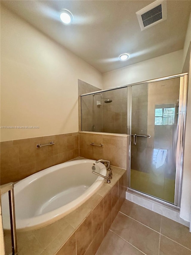 bathroom with tile patterned flooring and plus walk in shower