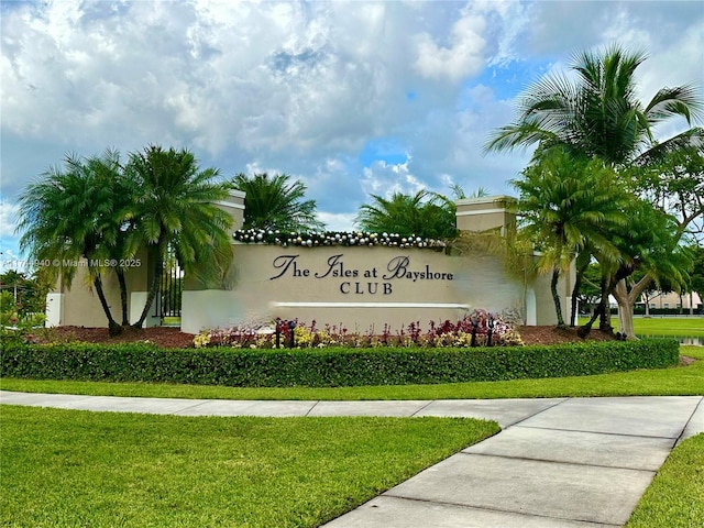 community sign featuring a lawn