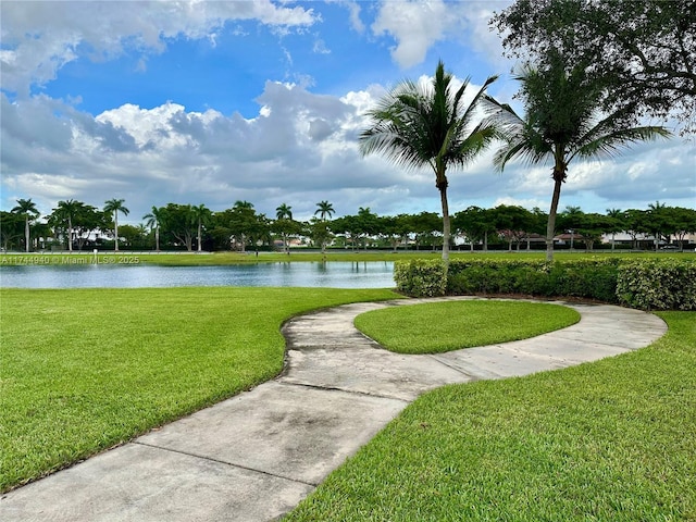 view of home's community featuring a water view and a lawn