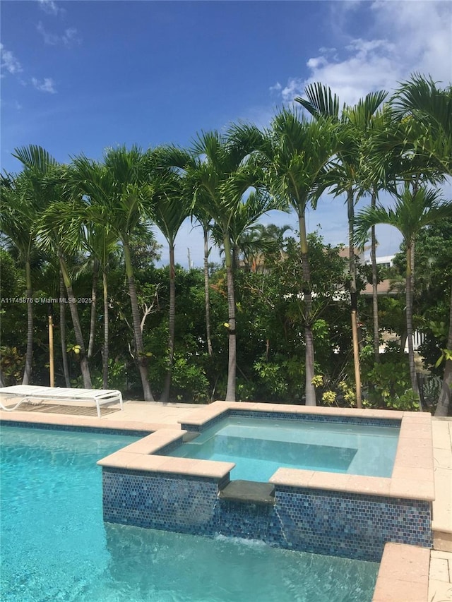 view of swimming pool with a pool with connected hot tub