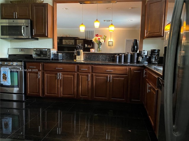 kitchen featuring a toaster, visible vents, decorative light fixtures, crown molding, and appliances with stainless steel finishes