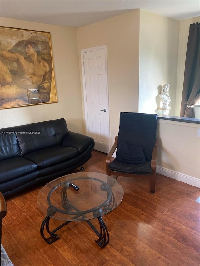 living room with wood finished floors and baseboards