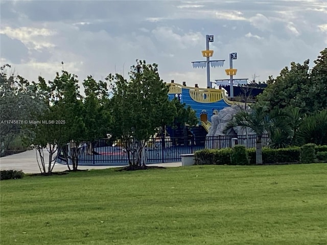 surrounding community with fence and a lawn