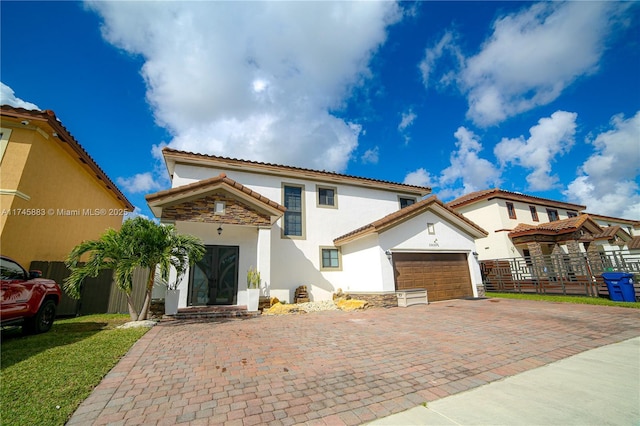 mediterranean / spanish house with a garage