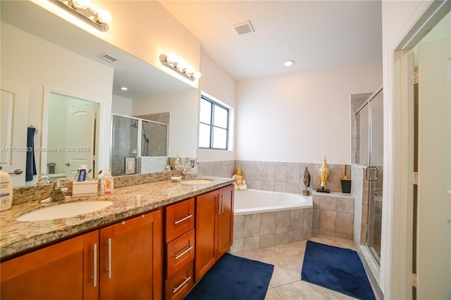 bathroom featuring vanity, tile patterned floors, and separate shower and tub