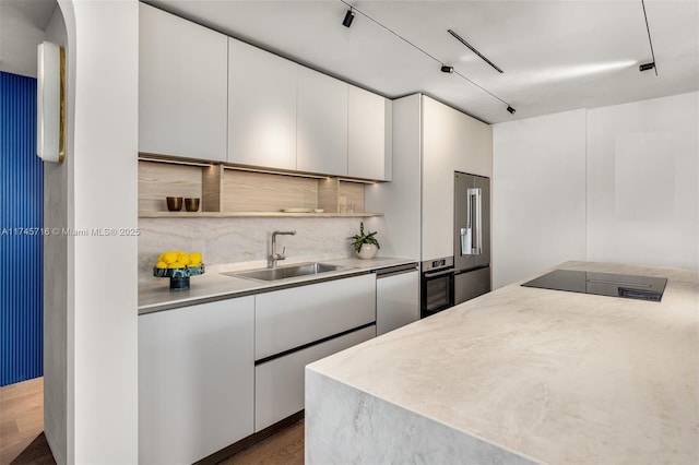 kitchen with white cabinetry, high quality fridge, dishwasher, and sink