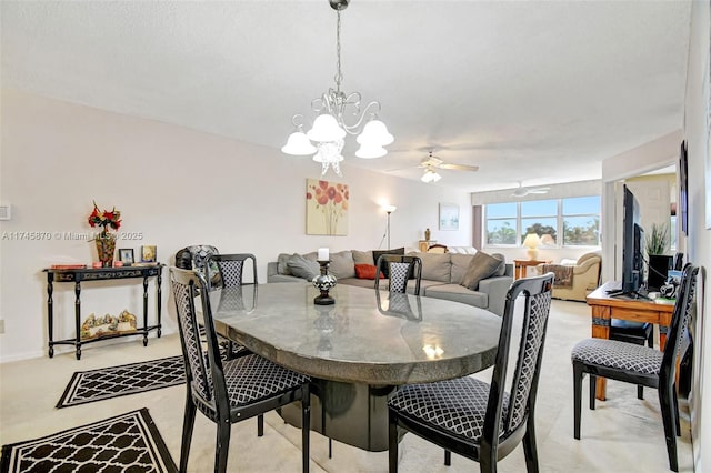 carpeted dining room with ceiling fan