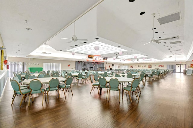 dining area featuring a raised ceiling, hardwood / wood-style floors, and ceiling fan