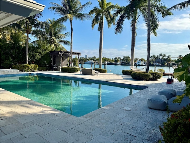 view of swimming pool featuring a water view, a pergola, and a patio