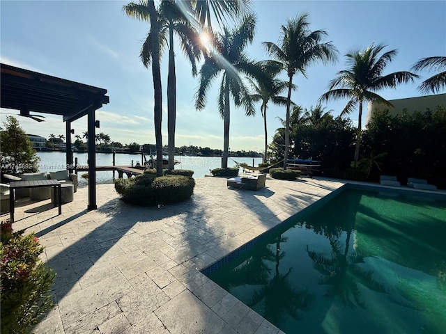 view of swimming pool featuring a water view, a pergola, and a patio area