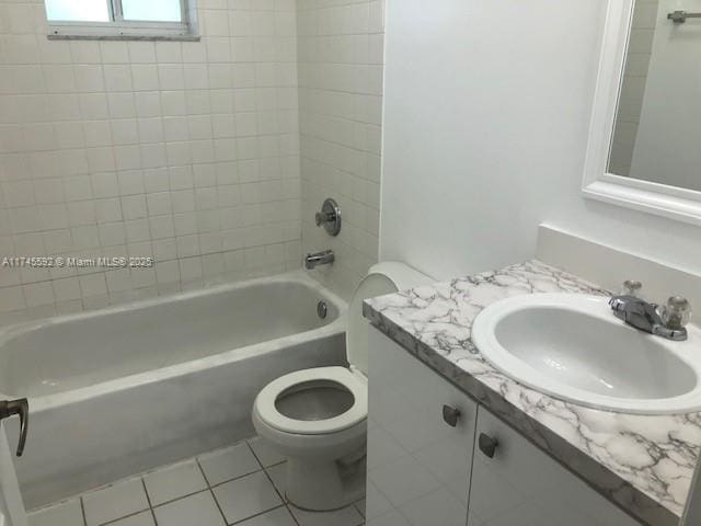 full bath with shower / washtub combination, vanity, toilet, and tile patterned floors