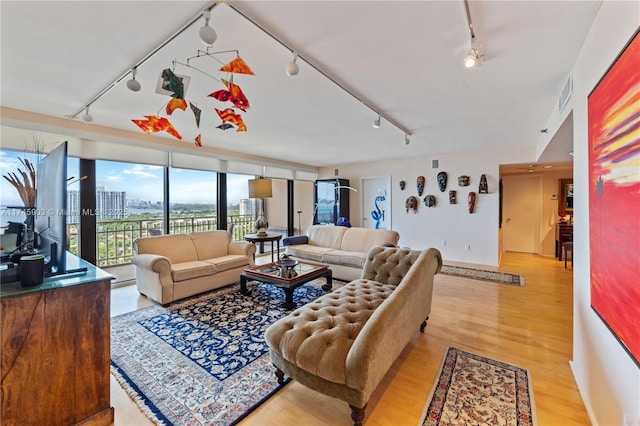 living room featuring track lighting and light hardwood / wood-style floors