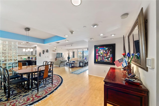 dining space featuring light hardwood / wood-style flooring and rail lighting