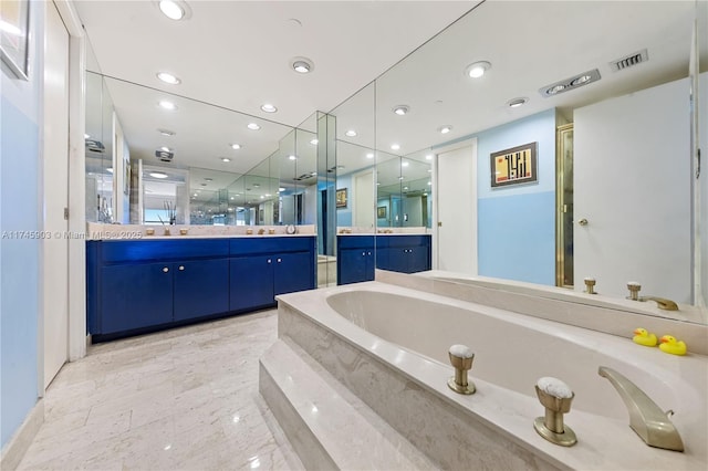 bathroom with vanity and independent shower and bath