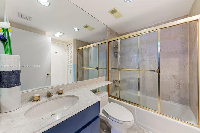 full bathroom with vanity, shower / bath combination with glass door, and toilet