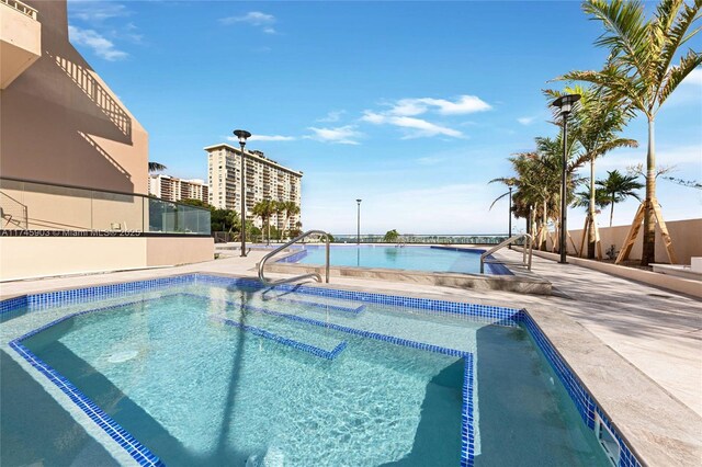 view of pool featuring a water view