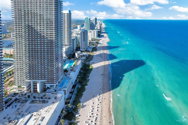 birds eye view of property featuring a beach view and a water view