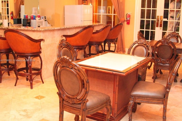 10717 Cleary Blvd Unit 203, Plantation, FL 33324 - bar featuring a bar, freestanding refrigerator, and french doors