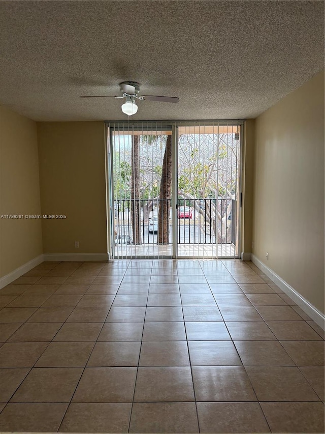 10717 Cleary Blvd Unit 203, Plantation, FL 33324 - empty room featuring a healthy amount of sunlight, ceiling fan, tile patterned flooring, and baseboards