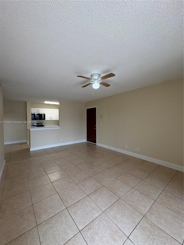 10717 Cleary Blvd Unit 203, Plantation, FL 33324 - spare room with light tile patterned flooring, ceiling fan, baseboards, and a textured ceiling