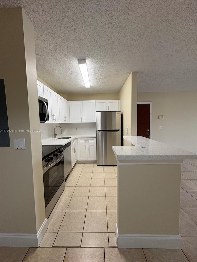 10717 Cleary Blvd Unit 203, Plantation, FL 33324 - kitchen featuring light tile patterned floors, stainless steel appliances, white cabinets, and a sink