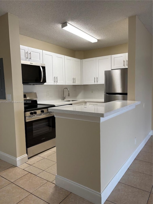 10717 Cleary Blvd Unit 203, Plantation, FL 33324 - kitchen with a sink, light tile patterned floors, white cabinetry, light countertops, and appliances with stainless steel finishes