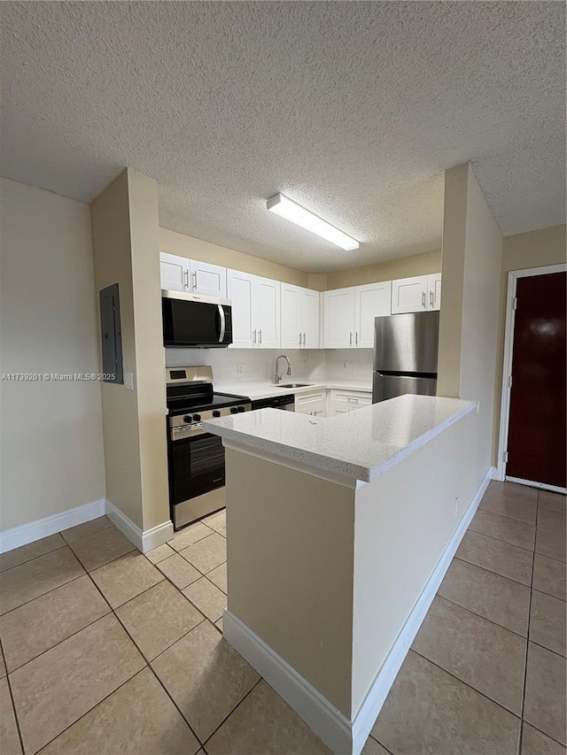 10717 Cleary Blvd Unit 203, Plantation, FL 33324 - kitchen featuring a sink, stainless steel appliances, light tile patterned floors, light countertops, and white cabinets