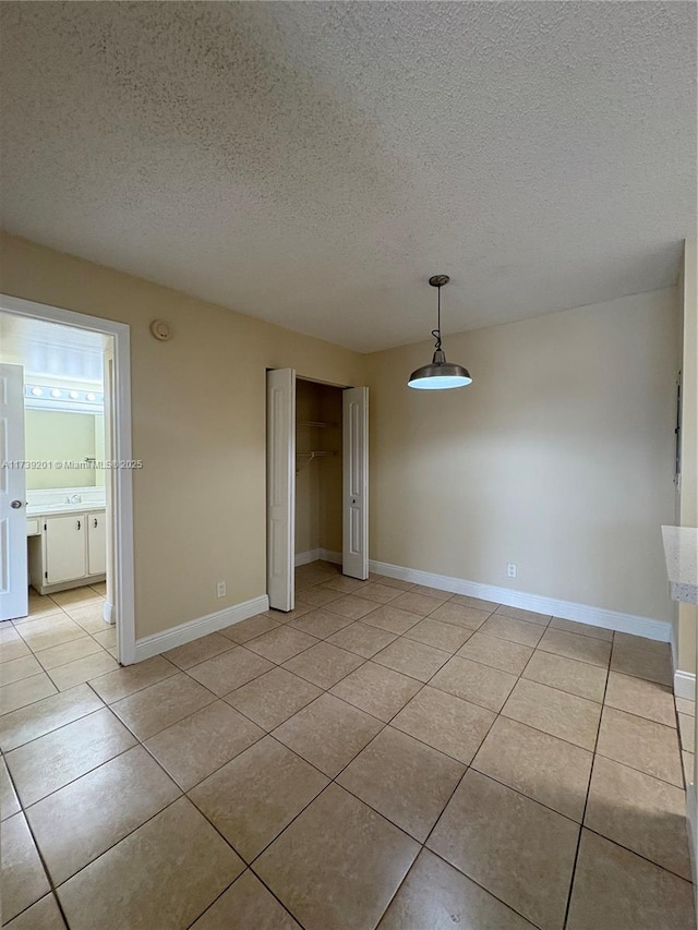 10717 Cleary Blvd Unit 203, Plantation, FL 33324 - interior space with light tile patterned floors, a textured ceiling, and baseboards