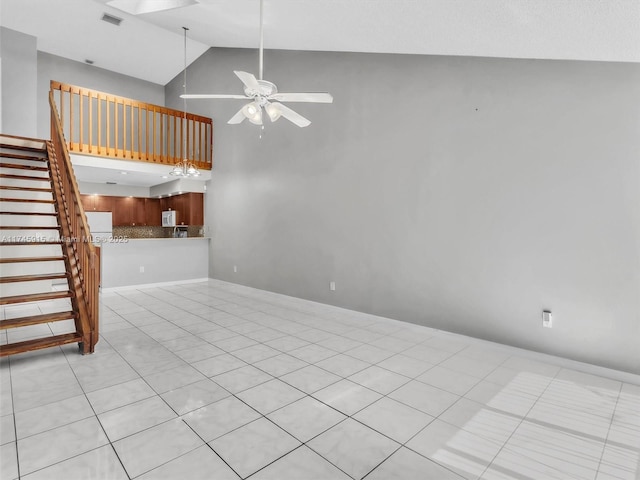 unfurnished living room featuring high vaulted ceiling, light tile patterned floors, and ceiling fan