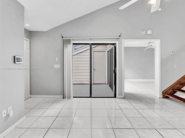 tiled empty room with vaulted ceiling and ceiling fan