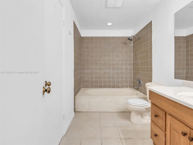 full bathroom with tiled shower / bath combo, vanity, tile patterned flooring, and toilet