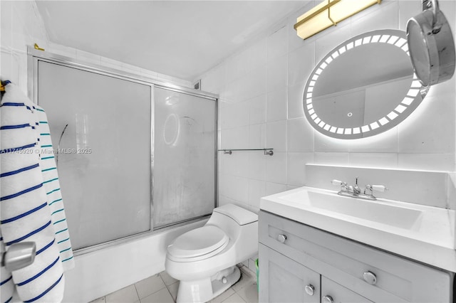 1020 Meridian Ave Unit 515, Miami Beach, FL 33139 - full bathroom with tile patterned floors, shower / bath combination with glass door, toilet, tile walls, and vanity